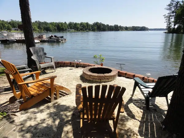 Cozy Lake Murray cabin rental with private dock and fire pit, overlooking the water at sunset
